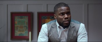 Movie still from “Fatherhood” (2021), directed by Paul Weitz – A person sitting in a room; Close Up shot, Over the shoulder angle