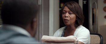 Movie still from “Fatherhood” (2021), directed by Paul Weitz – An older black woman looking at a man in the mirror; Close Up shot, Over the shoulder angle