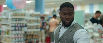 Movie still from “Fatherhood” (2021), directed by Paul Weitz – A person wearing a suit and tie; Close Up shot, Over the shoulder angle