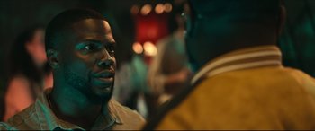 Movie still from “Fatherhood” (2021), directed by Paul Weitz – A man's face as he talks to another man; Close Up shot, Over the shoulder angle