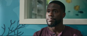 Movie still from “Fatherhood” (2021), directed by Paul Weitz – A person with a beard looking into the distance; Close Up shot, Over the shoulder angle