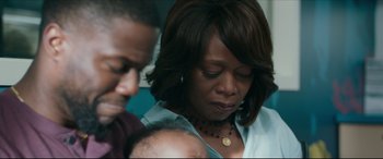 Movie still from “Fatherhood” (2021), directed by Paul Weitz – A woman holding a baby in her arms and looking down; Close Up shot, Over the shoulder angle