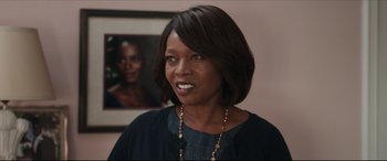 Movie still from “Fatherhood” (2021), directed by Paul Weitz – A person wearing a necklace; Close Up shot, Over the shoulder angle