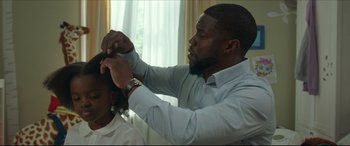 Movie still from “Fatherhood” (2021), directed by Paul Weitz – A man is cutting another man's hair with scissors; Close Up shot, Over the shoulder angle