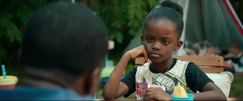 Movie still from “Fatherhood” (2021), directed by Paul Weitz – A little girl sitting in front of another little boy; Close Up shot, Over the shoulder angle