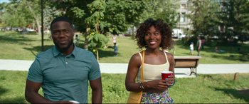 Movie still from “Fatherhood” (2021), directed by Paul Weitz – A woman standing next to a man holding a cup; Medium shot, Over the shoulder angle