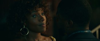 Movie still from “Fatherhood” (2021), directed by Paul Weitz – A person with curly black hair; Close Up shot, Over the shoulder angle