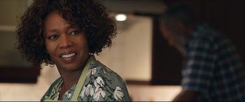 Movie still from “Fatherhood” (2021), directed by Paul Weitz – A person with curly black hair; Close Up shot, Over the shoulder angle