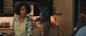 Movie still from “Fatherhood” (2021), directed by Paul Weitz – A man and a woman standing in a kitchen preparing a meal; Medium shot, Over the shoulder angle