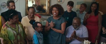 Movie still from “Fatherhood” (2021), directed by Paul Weitz – A group of people gathered around a woman; Medium shot, Over the shoulder angle