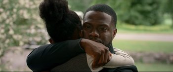 Movie still from “Fatherhood” (2021), directed by Paul Weitz – A man and a woman hugging each other in a park; Close Up shot, Over the shoulder angle