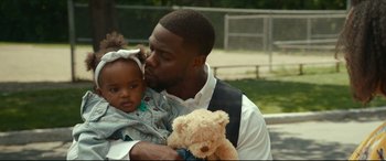Movie still from “Fatherhood” (2021), directed by Paul Weitz – A man holding a little girl and a teddy bear; Close Up shot, Over the shoulder angle