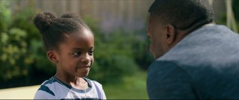 Movie still from “Fatherhood” (2021), directed by Paul Weitz – A little girl standing next to an older man outside; Close Up shot, Over the shoulder angle