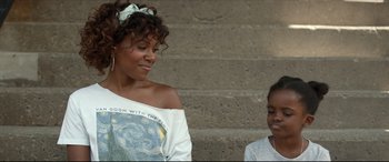 Movie still from “Fatherhood” (2021), directed by Paul Weitz – A woman standing next to another woman in front of a brick wall; Close Up shot, Over the shoulder angle