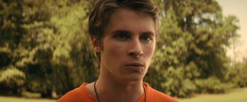 Movie still from “Fear Street: Part Two - 1978” (2021), directed by Leigh Janiak – A person wearing an orange shirt; Close Up shot, Over the shoulder angle