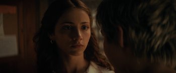 Movie still from “Fear Street: Part Two - 1978” (2021), directed by Leigh Janiak – A young woman looking at a young man in a dark room; Close Up shot, Over the shoulder angle