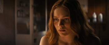 Movie still from “Fear Street: Part Two - 1978” (2021), directed by Leigh Janiak – A person with long red hair; Close Up shot, Over the shoulder angle