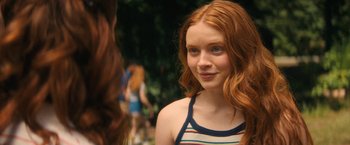 Movie still from “Fear Street: Part Two - 1978” (2021), directed by Leigh Janiak – A person with long red hair; Close Up shot, Over the shoulder angle