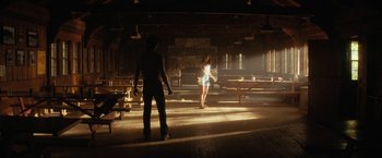 Movie still from “Fear Street: Part Two - 1978” (2021), directed by Leigh Janiak – A man and a woman are standing in a room; Wide shot, Low angle