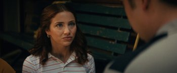 Movie still from “Fear Street: Part Two - 1978” (2021), directed by Leigh Janiak – A woman sitting in front of a man on a park bench; Close Up shot, Over the shoulder angle