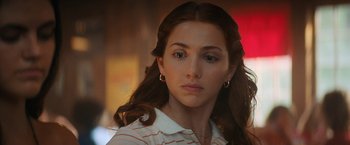 Movie still from “Fear Street: Part Two - 1978” (2021), directed by Leigh Janiak – A person with long brown hair; Close Up shot, Over the shoulder angle