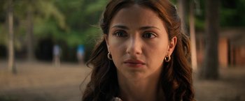 Movie still from “Fear Street: Part Two - 1978” (2021), directed by Leigh Janiak – A person wearing a earring; Close Up shot, Over the shoulder angle