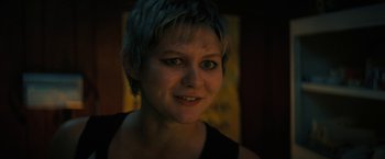 Movie still from “Fear Street: Part Two - 1978” (2021), directed by Leigh Janiak – A person with short blue hair; Close Up shot, Over the shoulder angle