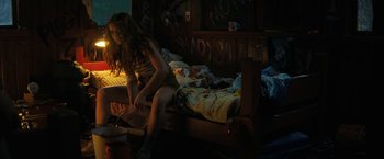 Movie still from “Fear Street: Part Two - 1978” (2021), directed by Leigh Janiak – A girl sitting on a bed in the dark; Medium shot, High angle