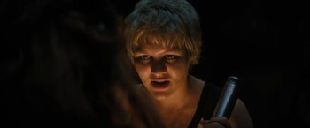 Movie still from “Fear Street: Part Two - 1978” (2021), directed by Leigh Janiak – A person with short blonde hair; Close Up shot, Low angle