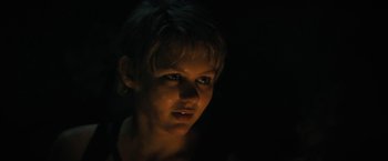 Movie still from “Fear Street: Part Two - 1978” (2021), directed by Leigh Janiak – A woman with short blonde hair stares into the light; Close Up shot, Over the shoulder angle