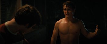 Movie still from “Fear Street: Part Two - 1978” (2021), directed by Leigh Janiak – A shirtless man standing next to a mirror; Medium shot, Over the shoulder angle