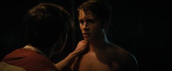 Movie still from “Fear Street: Part Two - 1978” (2021), directed by Leigh Janiak – A young man with his hands on his chest; Close Up shot, Over the shoulder angle