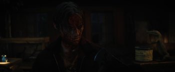 Movie still from “Fear Street: Part Two - 1978” (2021), directed by Leigh Janiak – A person with a knife in a dark room; Close Up shot, Over the shoulder angle