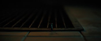 Movie still from “Fear Street: Part Two - 1978” (2021), directed by Leigh Janiak – A screw with a light shining on it; Extreme Close Up shot, Overhead angle