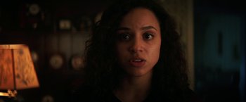 Movie still from “Fear Street: Part Two - 1978” (2021), directed by Leigh Janiak – A person with curly black hair; Close Up shot, Over the shoulder angle