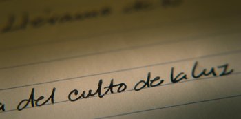 Movie still from “Feria: The Darkest Light” (2022), created by Carlos Montero – The words culto de 6 6 written in a notebook; Extreme Close Up shot, Low angle