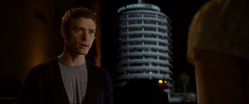 Movie still from “Friends with Benefits” (2011), directed by Will Gluck – A man standing in front of a building at night; Medium shot, Over the shoulder angle