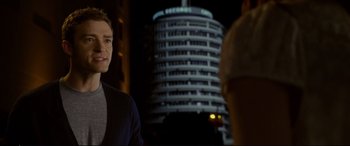 Movie still from “Friends with Benefits” (2011), directed by Will Gluck – A man standing in front of a building at night; Medium shot, Over the shoulder angle