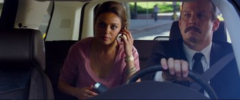 Movie still from “Friends with Benefits” (2011), directed by Will Gluck – A woman sitting in the back of a car talking on a cell phone; Medium shot, Over the shoulder angle