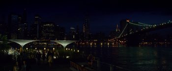 Movie still from “Friends with Benefits” (2011), directed by Will Gluck – People are sitting on a bench near a body of water at night; Extreme Wide shot, High angle