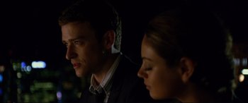 Movie still from “Friends with Benefits” (2011), directed by Will Gluck – A man and a woman sitting next to each other in the dark; Close Up shot, Over the shoulder angle