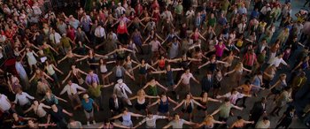 Movie still from “Friends with Benefits” (2011), directed by Will Gluck – A large group of people standing in the middle of a room; Extreme Wide shot, Overhead angle