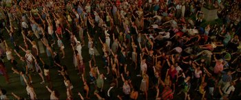 Movie still from “Friends with Benefits” (2011), directed by Will Gluck – A large group of people standing in the street; Extreme Wide shot, Overhead angle