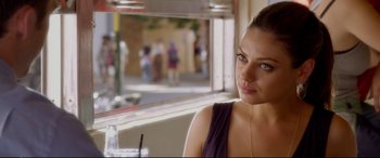 Movie still from “Friends with Benefits” (2011), directed by Will Gluck – A woman sitting at a table in front of a window; Close Up shot, Over the shoulder angle