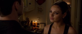 Movie still from “Friends with Benefits” (2011), directed by Will Gluck – A beautiful young woman with a black top; Close Up shot, Over the shoulder angle