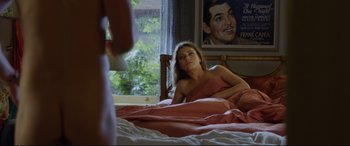 Movie still from “Friends with Benefits” (2011), directed by Will Gluck – A beautiful young woman laying in bed next to a window; Medium shot, Over the shoulder angle