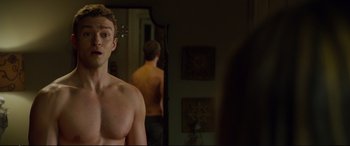 Movie still from “Friends with Benefits” (2011), directed by Will Gluck – A man standing in front of a bathroom mirror; Medium shot, Over the shoulder angle