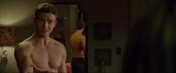 Movie still from “Friends with Benefits” (2011), directed by Will Gluck – A man standing in front of a bathroom mirror; Medium shot, Over the shoulder angle