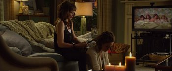 Movie still from “Friends with Benefits” (2011), directed by Will Gluck – Two women sitting in a living room next to candles; Medium shot, Over the shoulder angle