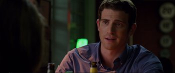 Movie still from “Friends with Benefits” (2011), directed by Will Gluck – A person sitting at a table with a beer; Close Up shot, Over the shoulder angle